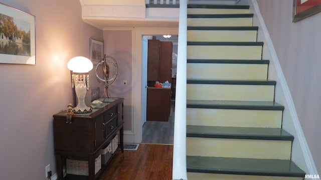 stairway with hardwood / wood-style floors