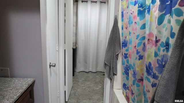 bathroom featuring vanity and shower / bath combo with shower curtain