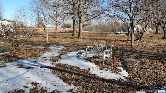 snowy yard featuring a rural view