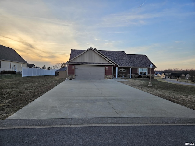 view of front of property with a garage and a lawn