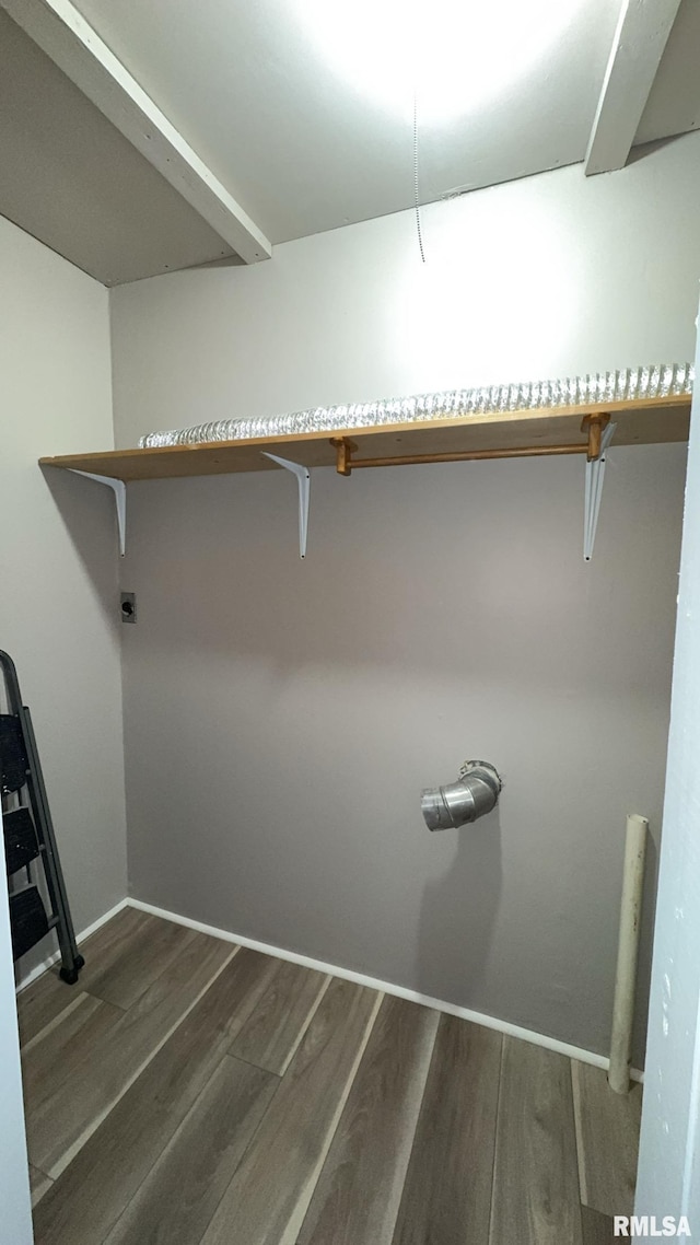 spacious closet featuring dark hardwood / wood-style flooring