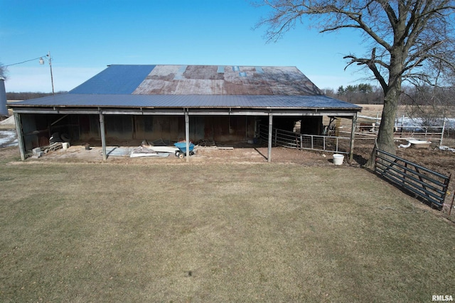 back of property featuring an outbuilding