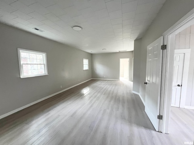 unfurnished room featuring a healthy amount of sunlight and light wood-type flooring