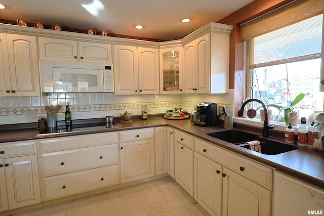 kitchen with sink, white cabinets, white appliances, and decorative backsplash