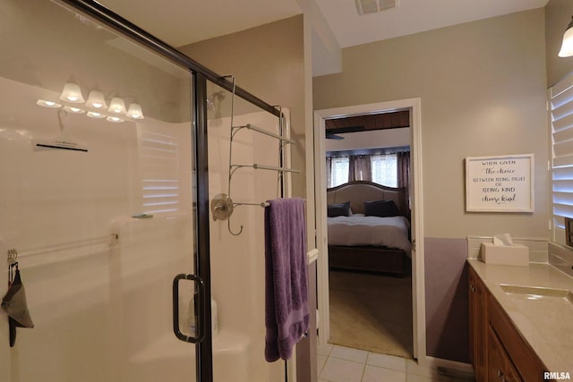 bathroom with tile patterned floors, a shower with shower door, and vanity