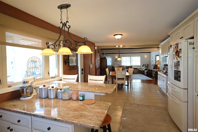 205 E Jennings, Salem, IL 62881 - kitchen featuring freestanding refrigerator, light tile patterned flooring, hanging light fixtures, and open floor plan