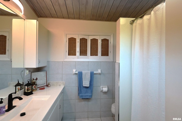 bathroom with tile walls, vanity, curtained shower, wooden ceiling, and toilet