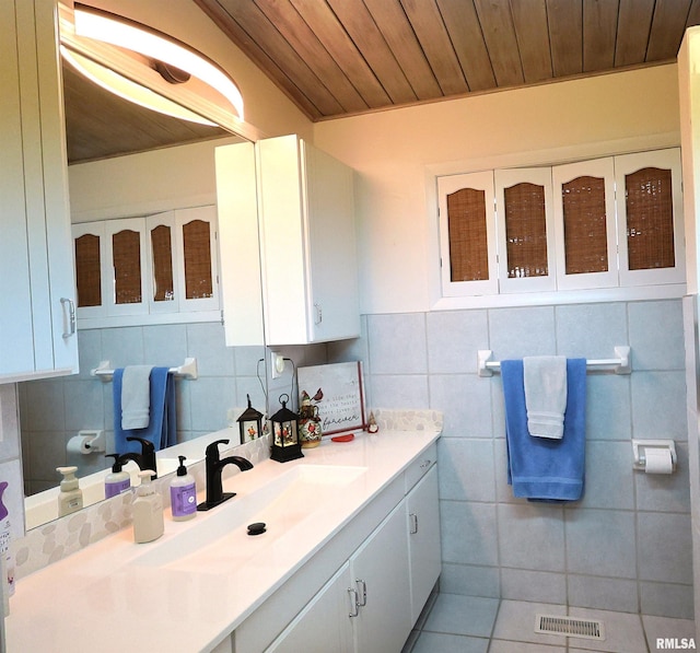 bathroom featuring vanity, tile walls, wooden ceiling, and decorative backsplash