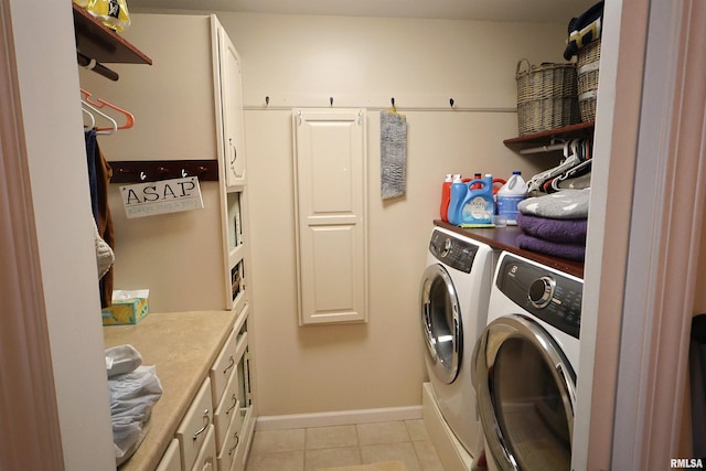205 E Jennings, Salem, IL 62881 - clothes washing area featuring washing machine and clothes dryer, cabinet space, light tile patterned floors, and baseboards