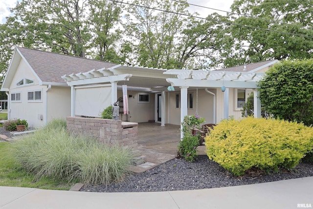 205 E Jennings, Salem, IL 62881 - ranch-style house with stucco siding, a pergola, and roof with shingles