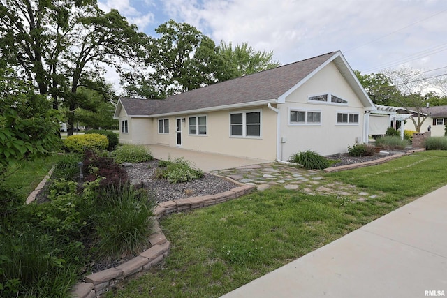 205 E Jennings, Salem, IL 62881 - view of side of property with stucco siding, a lawn, and roof with shingles