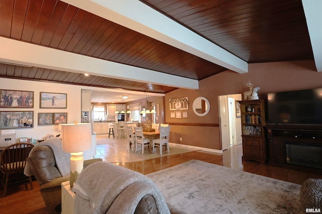 living room with wooden ceiling, light wood-type flooring, and vaulted ceiling with beams