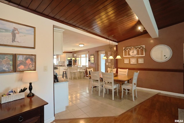 dining space with wood ceiling, a notable chandelier, lofted ceiling, and light tile patterned floors