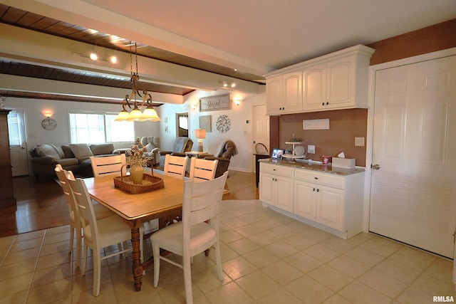 dining space with wood ceiling, light tile patterned floors, and beam ceiling