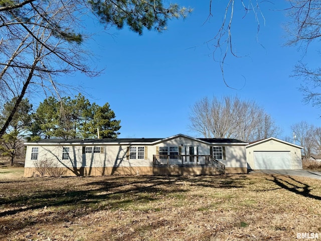 ranch-style home featuring a garage, a wooden deck, and a front yard