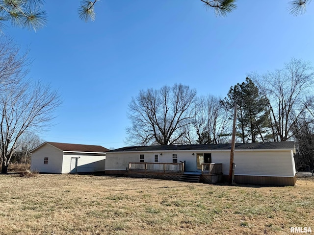 rear view of house with a yard and a deck