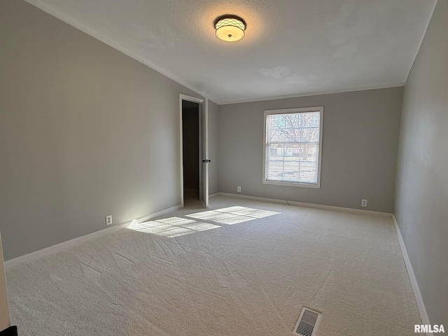 carpeted empty room featuring lofted ceiling and a textured ceiling