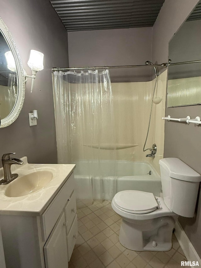 bathroom featuring tile patterned flooring, vanity, toilet, and shower / bath combo with shower curtain