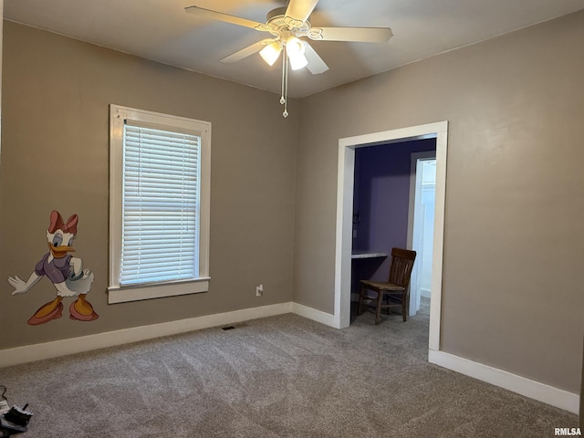 unfurnished bedroom with a ceiling fan, carpet flooring, visible vents, and baseboards