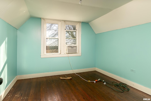 additional living space featuring dark hardwood / wood-style flooring and vaulted ceiling