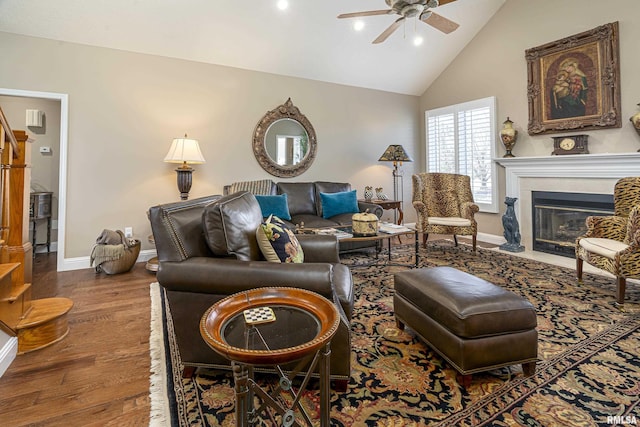 living room with wood-type flooring, high vaulted ceiling, and ceiling fan