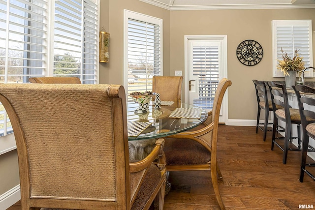 dining space featuring crown molding and dark wood-type flooring