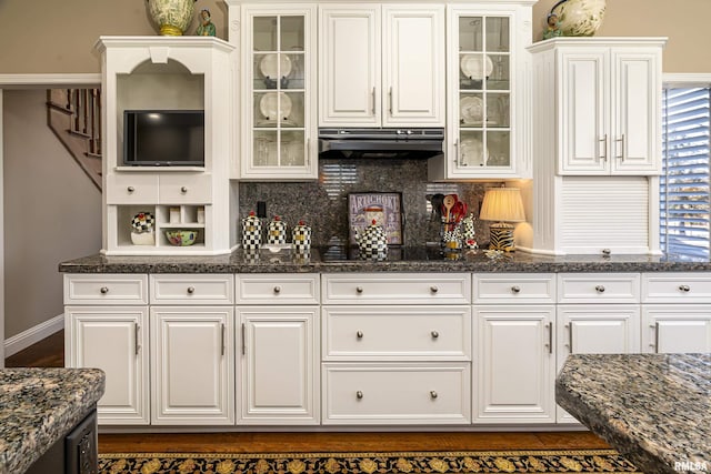 kitchen featuring white cabinetry and exhaust hood