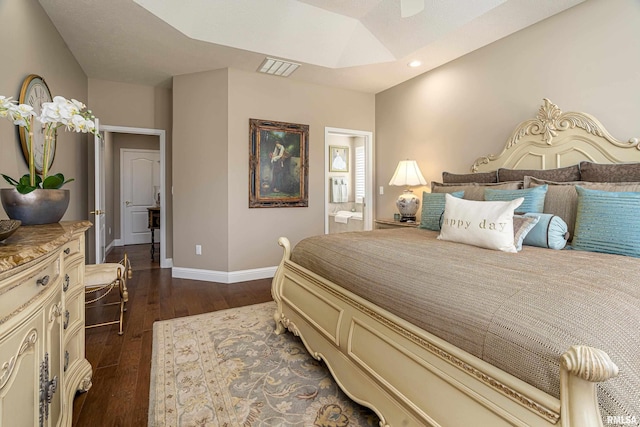 bedroom featuring ensuite bath and dark hardwood / wood-style flooring