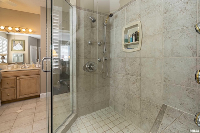 bathroom featuring a shower with door, vanity, and tile patterned flooring