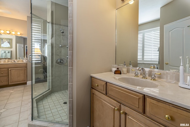 bathroom featuring tile patterned flooring, vanity, and a shower with door