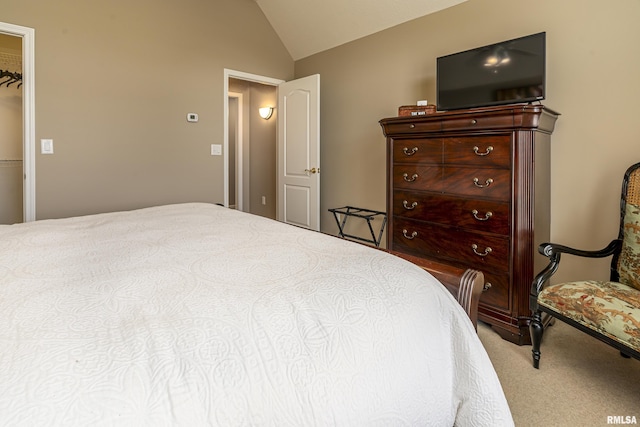 carpeted bedroom with lofted ceiling