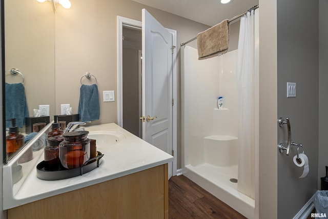 bathroom featuring vanity, hardwood / wood-style floors, and a shower with shower curtain