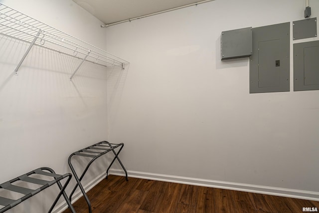 spacious closet with dark wood-type flooring and electric panel