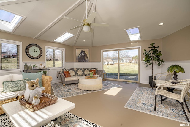 living room featuring lofted ceiling, plenty of natural light, concrete floors, and ceiling fan