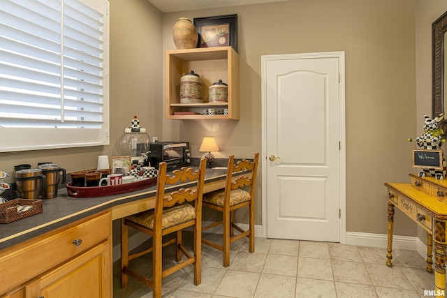 tiled office space featuring built in desk