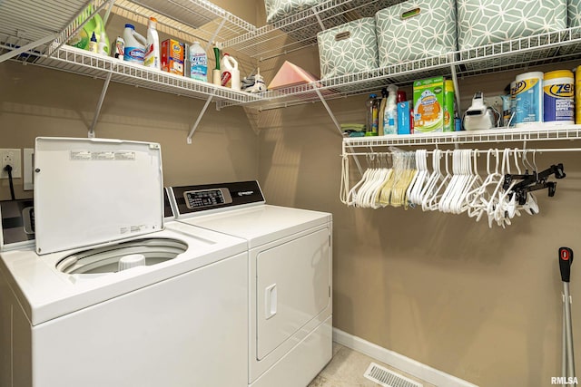 washroom with independent washer and dryer