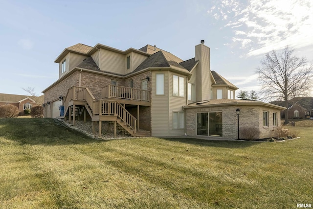 back of property featuring a garage, a wooden deck, and a lawn