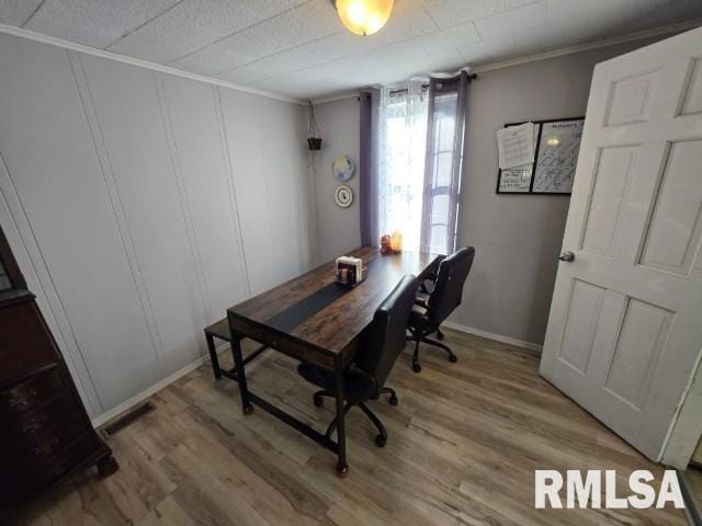 office area with ornamental molding and hardwood / wood-style floors