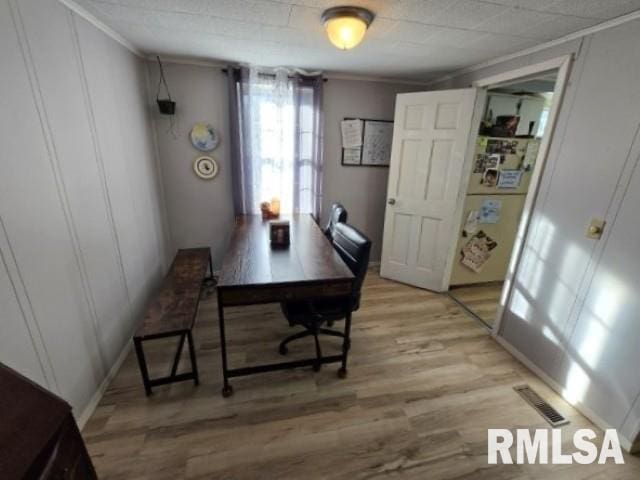 office space with crown molding and light hardwood / wood-style floors