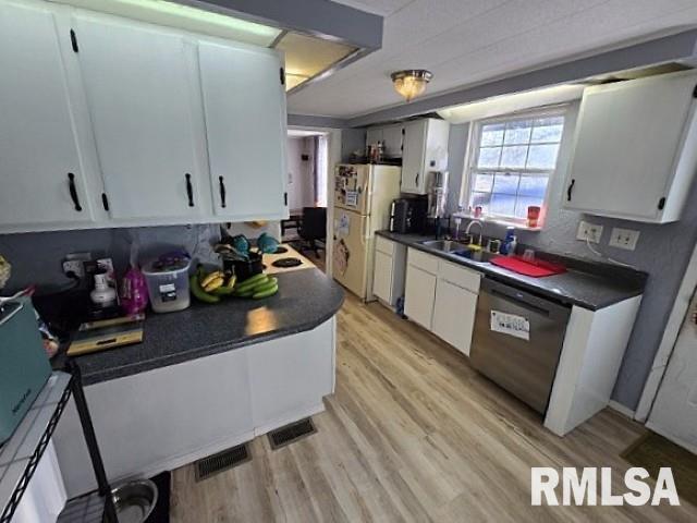 kitchen with sink, white cabinetry, white refrigerator, stainless steel dishwasher, and light wood-type flooring