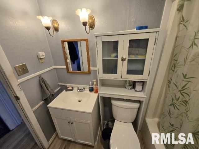 bathroom with vanity, hardwood / wood-style floors, and toilet