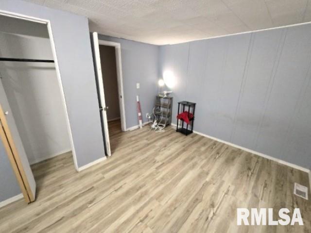 unfurnished bedroom featuring light wood-type flooring