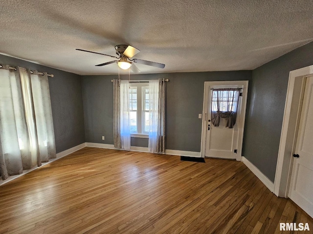 entryway featuring ceiling fan, hardwood / wood-style floors, and a textured ceiling