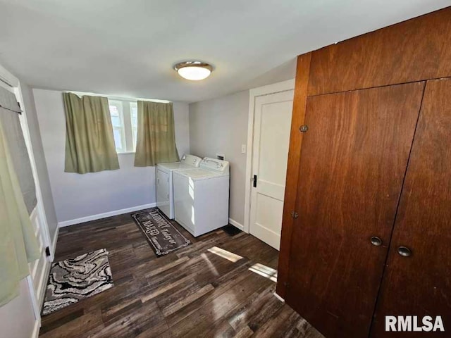 clothes washing area with washer and dryer and dark hardwood / wood-style floors