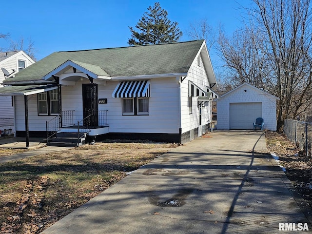 bungalow with a garage and an outdoor structure