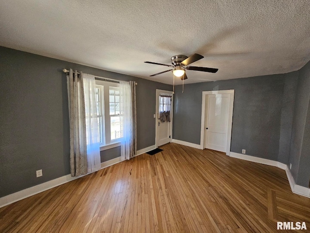 interior space featuring wood-type flooring, a textured ceiling, and ceiling fan