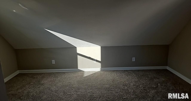 bonus room featuring vaulted ceiling and carpet