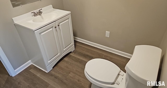 bathroom featuring vanity, hardwood / wood-style floors, and toilet