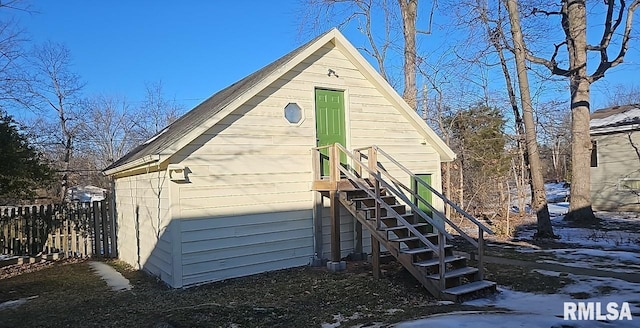 view of snow covered back of property