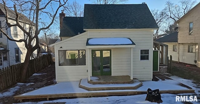 view of snow covered back of property